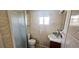 Compact bathroom with a glass-enclosed shower, white toilet, and practical vanity, designed for everyday convenience at 10315 Cortez W Rd # 16E, Bradenton, FL 34210
