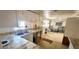 Practical kitchen with granite countertops and white cabinetry, seamlessly connected to a comfortable lounge area at 10315 Cortez W Rd # 16E, Bradenton, FL 34210