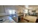 Functional kitchen with modern countertops and stainless steel sink, adjacent to a cozy sitting area at 10315 Cortez W Rd # 16E, Bradenton, FL 34210