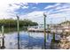 Picturesque waterfront view of boats docked alongside mangroves, enhanced by the natural beauty of pelicans resting nearby at 10315 Cortez W Rd # 16E, Bradenton, FL 34210