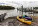 Tranquil waterfront with nearby docks and colorful kayaks ready for water adventures at 10315 Cortez W Rd # 16E, Bradenton, FL 34210