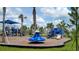 A community playground has many blue structures, including slides and climbing areas at 12128 Kingsley Trl, Parrish, FL 34219