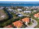 Stunning aerial view of the waterfront community with scenic bridge and lush landscaping at 12518 Harbour Landings Dr, Cortez, FL 34215