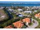 Aerial shot of the property showcasing its location, red roof, and waterfront access at 12518 Harbour Landings Dr, Cortez, FL 34215