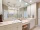 Bright bathroom with dual sinks, vanity area, large mirror, and access to the shower and tub at 12518 Harbour Landings Dr, Cortez, FL 34215