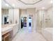 Spacious bathroom featuring double sinks, a large mirror, and a separate shower and tub at 12518 Harbour Landings Dr, Cortez, FL 34215