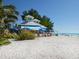 Outdoor beachside restaurant with bright blue awnings and ocean views at 12518 Harbour Landings Dr, Cortez, FL 34215