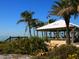 Scenic beachside restaurant with views of palm trees and the ocean at 12518 Harbour Landings Dr, Cortez, FL 34215