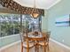 Cozy dining area with a chandelier and a view of the lanai at 12518 Harbour Landings Dr, Cortez, FL 34215