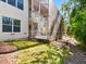 Exterior view of a screened-in patio with a spiral staircase and lush landscaping at 12518 Harbour Landings Dr, Cortez, FL 34215