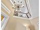 Bright foyer featuring a decorative chandelier and view of the second-floor landing at 12518 Harbour Landings Dr, Cortez, FL 34215