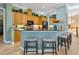 Kitchen showcasing wooden cabinets, granite countertops, and bar seating at 12518 Harbour Landings Dr, Cortez, FL 34215