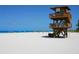 Elevated lifeguard stand on a sandy beach, under a blue sky at 12518 Harbour Landings Dr, Cortez, FL 34215