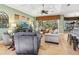 Open-concept living room with comfortable seating and a large sliding glass door with lanai view at 12518 Harbour Landings Dr, Cortez, FL 34215