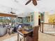 Open concept living room with lots of natural light, desk, and kitchen view with bar seating at 12518 Harbour Landings Dr, Cortez, FL 34215