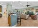 Bright living room with modern decor, ceiling fan, and an open layout connected to the kitchen at 12518 Harbour Landings Dr, Cortez, FL 34215