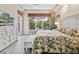 Cozy main bedroom with large windows, a ceiling fan, and views of lush greenery at 12518 Harbour Landings Dr, Cortez, FL 34215