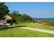 Picturesque park with a thatched-roof hut, walking paths, and benches overlooking the water at 12518 Harbour Landings Dr, Cortez, FL 34215