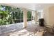 Screened patio with outdoor seating and a grill, overlooking lush tropical foliage at 12518 Harbour Landings Dr, Cortez, FL 34215