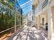 Screened-in patio featuring a spiral staircase leading to upper floors at 12518 Harbour Landings Dr, Cortez, FL 34215