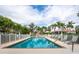Inviting swimming pool with lounge chairs and tropical landscaping offering a relaxing outdoor space at 12518 Harbour Landings Dr, Cortez, FL 34215