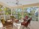 Screened porch featuring comfortable seating and a ceiling fan for relaxing outdoors at 12518 Harbour Landings Dr, Cortez, FL 34215