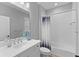 Modern bathroom with a sleek vanity, large mirror, and shower-tub combo with stylish curtain at 14147 Campfire Ct, Parrish, FL 34219