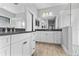 Bright bathroom with a double vanity, a large mirror, and a glass-enclosed shower with stylish tile at 14147 Campfire Ct, Parrish, FL 34219