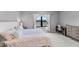 Bright bedroom featuring neutral decor, large window with serene water view, desk and chair, and dresser at 14147 Campfire Ct, Parrish, FL 34219