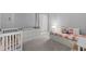 Bright bedroom with a daybed, crib, and ample storage, ideal for a growing Gathering at 14147 Campfire Ct, Parrish, FL 34219