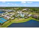 A beautiful view of the community pool, pickleball courts, and lake at 14147 Campfire Ct, Parrish, FL 34219