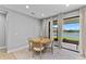 Bright dining area with natural lighting, a wooden round table and sliding glass doors overlooking water at 14147 Campfire Ct, Parrish, FL 34219