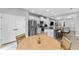 Open-concept kitchen features stainless steel appliances, counter seating, and dining area, perfect for modern living at 14147 Campfire Ct, Parrish, FL 34219