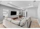 Open living room featuring a comfortable sectional sofa, tray ceiling and wood flooring at 14147 Campfire Ct, Parrish, FL 34219
