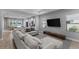 Relaxing living room featuring comfortable seating, a TV, and views to the kitchen and lake at 14147 Campfire Ct, Parrish, FL 34219