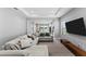 Inviting living room featuring a sectional sofa, a TV, and an open concept layout at 14147 Campfire Ct, Parrish, FL 34219