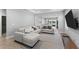 Spacious living room with a sectional sofa, TV, and views of the kitchen and backyard at 14147 Campfire Ct, Parrish, FL 34219