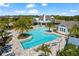 Beautiful aerial shot of a community pool with plenty of seating and palm trees at 14147 Campfire Ct, Parrish, FL 34219