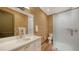 Bathroom with patterned wallpaper, modern white vanity, and a glass-enclosed shower at 1440 Kimlira Ln, Sarasota, FL 34231