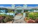 Charming front entrance with colorful landscaping, dormer windows, and a bright exterior at 1440 Kimlira Ln, Sarasota, FL 34231