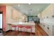 Modern kitchen features white cabinets, stainless appliances, island and eat-in bar at 1440 Kimlira Ln, Sarasota, FL 34231
