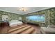 Main bedroom featuring stunning waterfront view and decorative wallpaper at 1440 Kimlira Ln, Sarasota, FL 34231