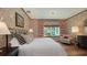 A beautifully designed main bedroom featuring patterned wallpaper, natural light, and comfortable seating at 1440 Kimlira Ln, Sarasota, FL 34231