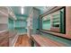 Spacious walk-in closet featuring custom shelving, wood floors, and a decorative full-length mirror at 1440 Kimlira Ln, Sarasota, FL 34231