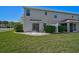 Backyard of home showing the grassy lawn, landscaping, patio and back of house at 14747 Amberjack Ter, Lakewood Ranch, FL 34202