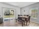 Open dining area with a wooden table set, bench, sliding glass doors to the backyard, and wood-look flooring at 14747 Amberjack Ter, Lakewood Ranch, FL 34202