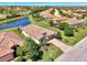 An aerial view showcases the home, landscaping, and its location on the water at 167 Wandering Wetlands Cir, Bradenton, FL 34212