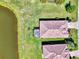 Overhead view of a home with a screened lanai next to a pond, in a landscaped community at 167 Wandering Wetlands Cir, Bradenton, FL 34212