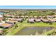 Aerial view of a property with a large pond in the backyard and beautiful community at 167 Wandering Wetlands Cir, Bradenton, FL 34212
