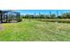 Lush green backyard with a screened-in patio and views of the pond at 167 Wandering Wetlands Cir, Bradenton, FL 34212